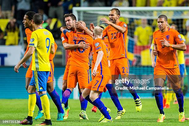 Wesley Sneijder of the Netherlands and teammates celebrate his 1-1 equalizing goal during the 2018 FIFA World Cup Qualifier match between Sweden and...