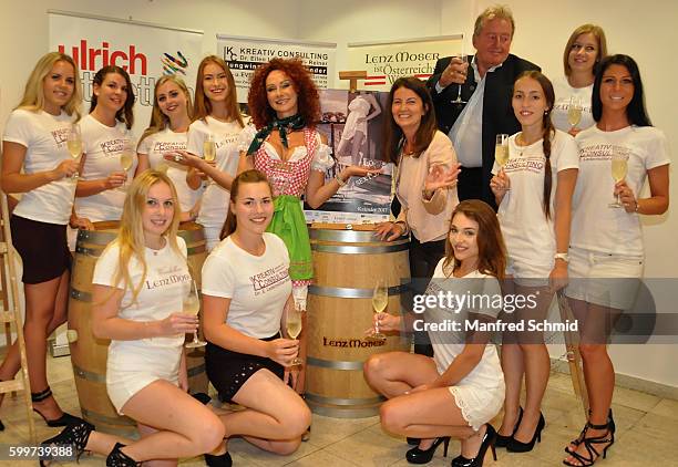 Christina Lugner, Ellen Ledermueller-Reiner and Karl Ulrich pose with models during the presentation of the vintner calendar 2017 at Ulrich Etiketten...