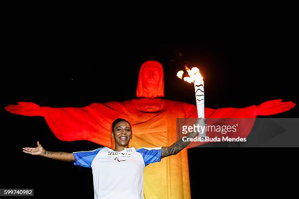Brazil's judo athlete Rafaela Silva holds the Olympic torch during the Paralympic torch ceremony at the Christ the Redeemer statue ahead of the 2016...