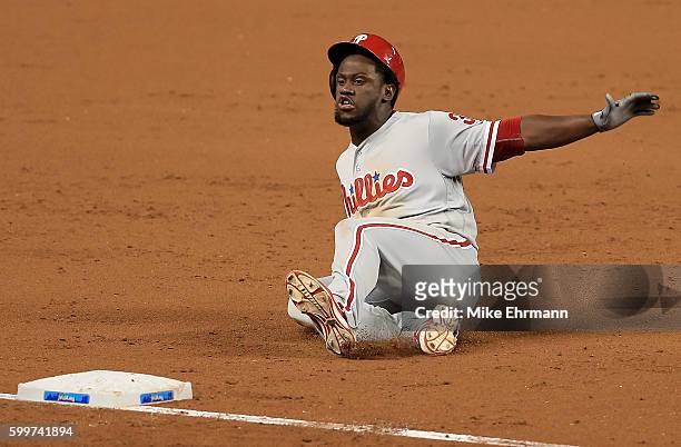 Odubel Herrera of the Philadelphia Phillies slides into third on a triple during a game against the Miami Marlins at Marlins Park on September 6,...