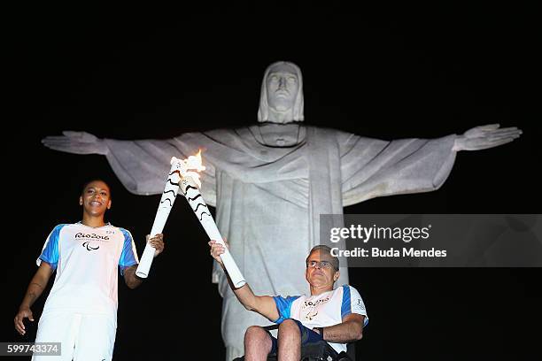 Brazilian judo gold medalist Rafaela Silva and Tomas Magalhaes, member of the Archdiocese of Rio de Janeiro, carry Paralympic torches in front of the...