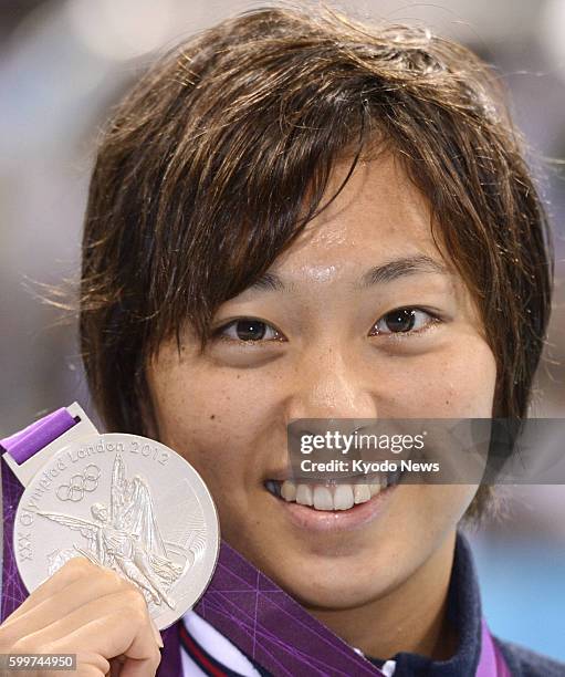 Britain - Japan's Satomi Suzuki shows the silver medal she won in the women's 200-meter breaststroke at the 2012 London Olympics, at the Aquatics...