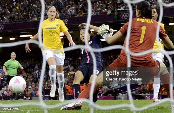 Wales - Japan's Yuki Ogimi scores the team's opening goal during the first half of a women's soccer quarterfinal match against Brazil at Millennium...