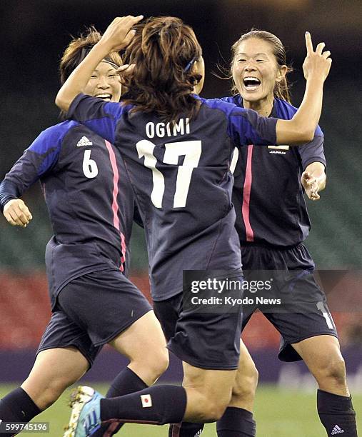 Wales - Japan's Yuki Ogimi celebrates with her teammates Homare Sawa and Mizuho Sakaguchi after scoring the team's opening goal during the first half...