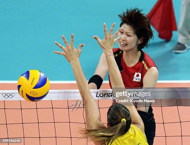 Britain - Japan's Saori Kimura spikes the ball during the first set of a match against Brazil in the women's volleyball semifinals at Earls Court at...