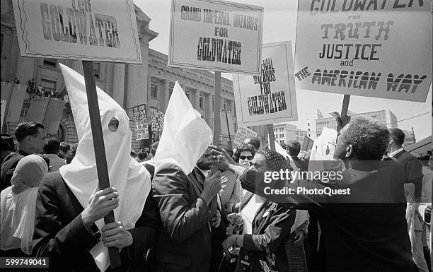 Ku Klux Klan members supporting Barry Goldwater's campaign for the presidential nomination at the Republican National Convention, as an African...