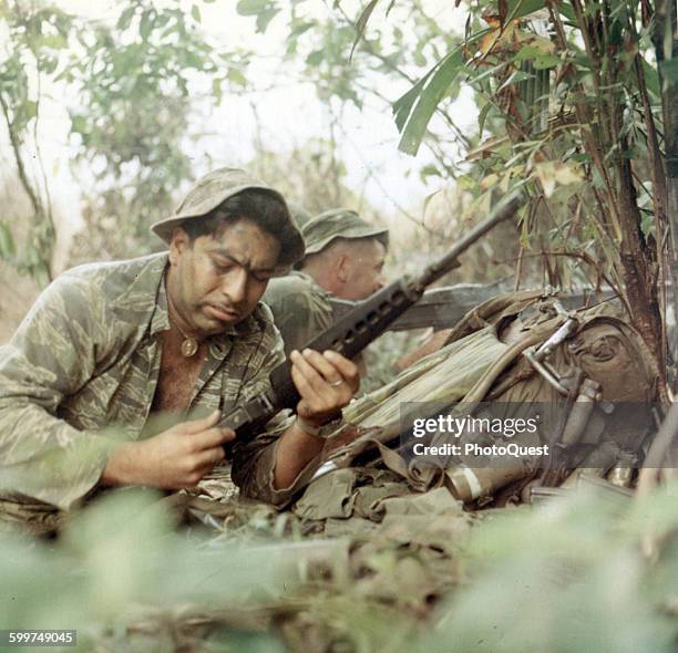 Members of a Long Range Patrol Team open fire against the enemy, Viet Nam, September 19, 1969. R-1 are: SP4 Salvador Romero, Senior Scout Observer,...