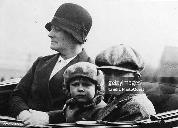 Princess Elizabeth, with George Lascelles, the son of Princess Mary, go for a drive at Windsor Palace, accompanied by a nanny, London, England, April...