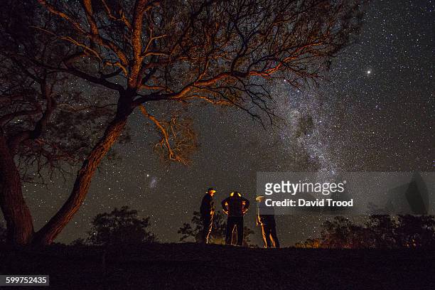 three men standing by a campfire under the milky w - australia fire - fotografias e filmes do acervo