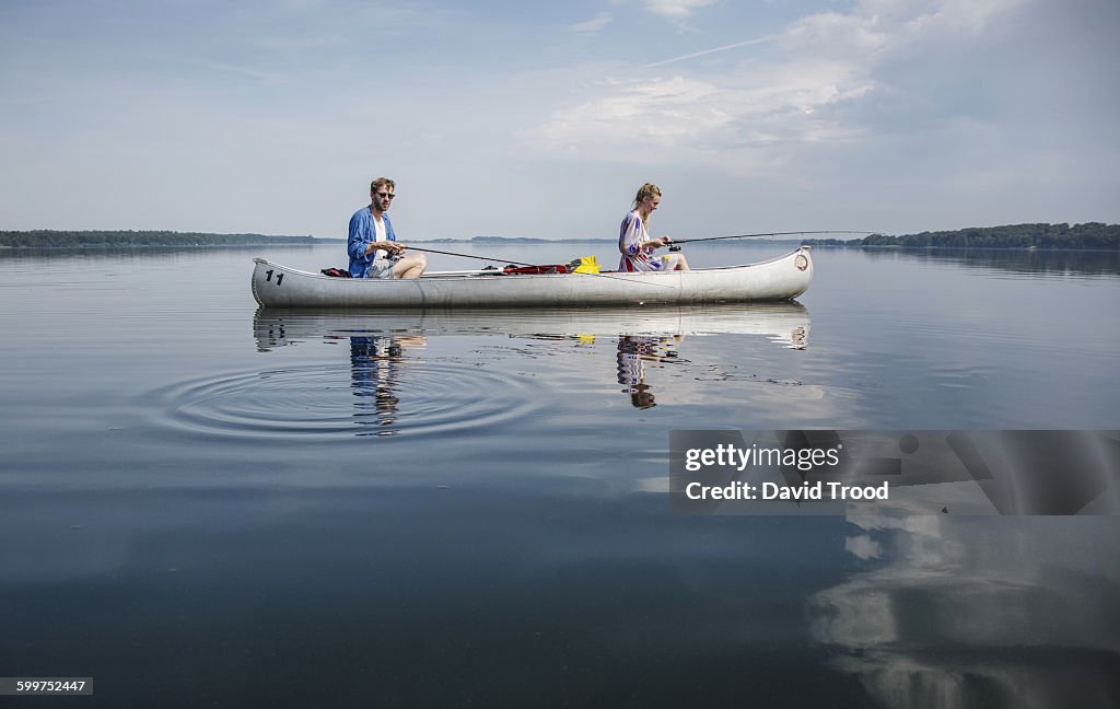 Couple fishing on a calm lake.