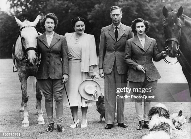 The two princesses, Elizabeth, left, and Margaret Rose, right, pose with Their Majesties, Queen Elizabeth and King George VI, before setting off on...