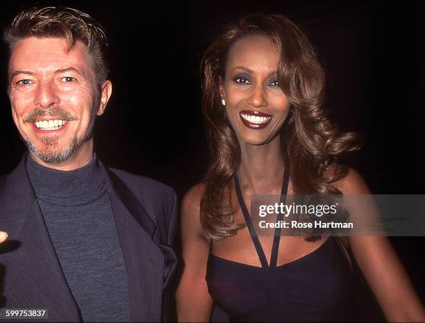 English musician, singer-songwriter, and actor David Bowie and his wife Somali fashion model Iman leaving a theatre on Broadway, New York City, circa...