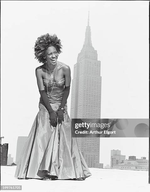 American Idol competitor, Nadia Turner poses in a floor length gown and long gloves, with the Empire State building in the background. "In a world of...