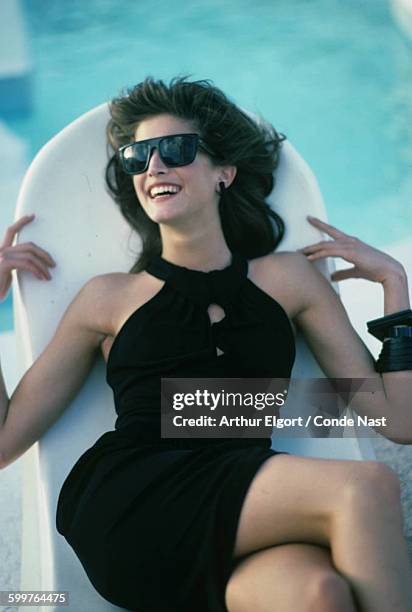 Model Stephanie Seymour wearing short rayon matte jersey dress with cut-in shoulers from OMO Norma Kamali. CREDIT MUST READ: Arthur Elgort/Conde Nast...