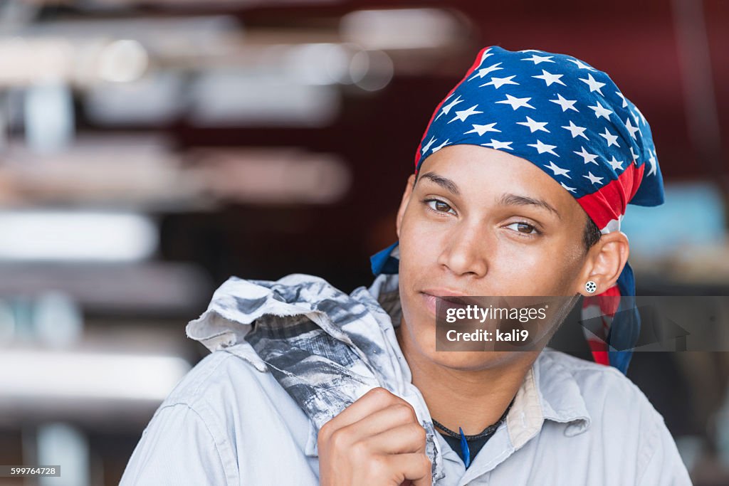 Young female American worker in factory
