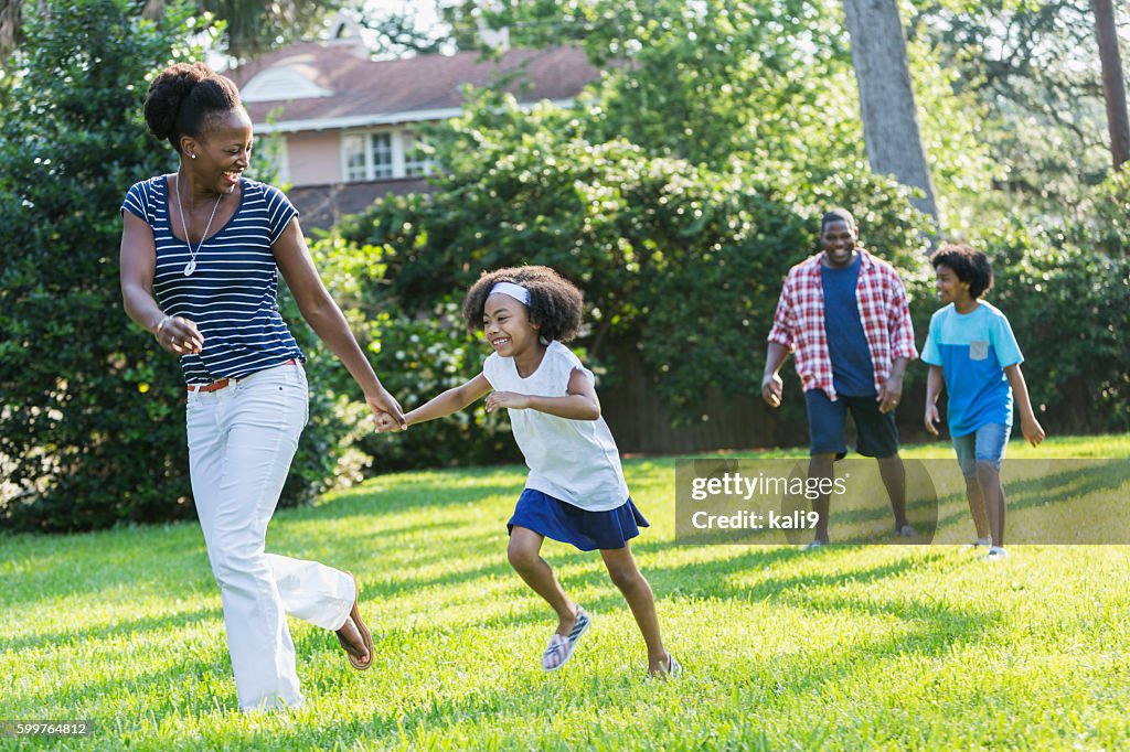 Family with mixed race children outdoor playing, walking
