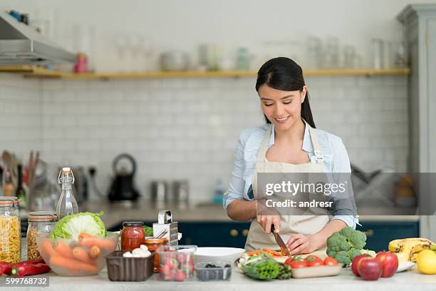 woman cooking at home - cooking apron stock pictures, royalty-free photos & images