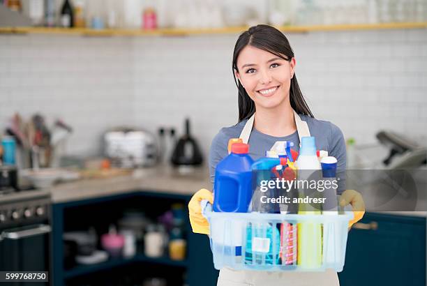 housekeeper holding cleaning products - cleaner smiling stock pictures, royalty-free photos & images