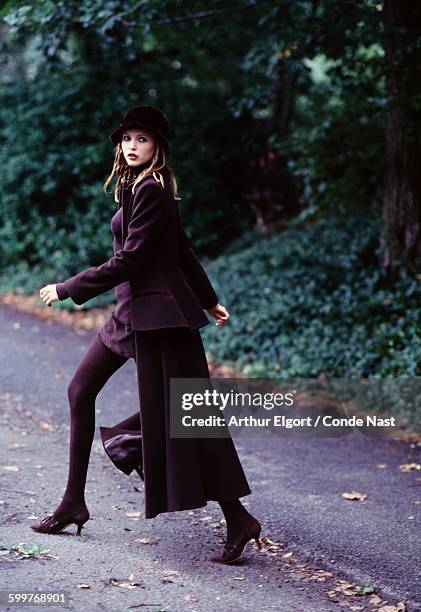 Model, Nadja Auermann, wearing Emporio Armani's long Victorian inspired coat with corduroy skirt and turtleneck CREDIT MUST READ: Arthur Elgort/Conde...
