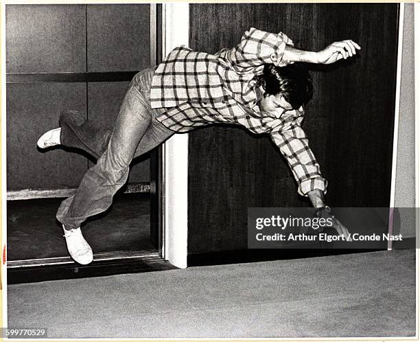 Comedian actor Chevy Chase feigning a fall out of an elevator CREDIT MUST READ: Arthur Elgort/Conde Nast via Getty Images.