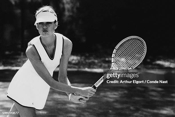 Model Beska Sorensen, playing tennis at Amelia Island Plantation resort, in Florida, wearing a white sleeveless tennis top and skirt with piping by...