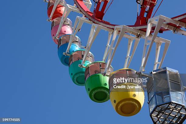 colorful cute ferris wheel - telephoto lens stock pictures, royalty-free photos & images