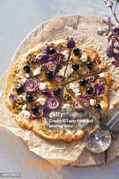 sliced vegetarian pizza - black olive stock pictures, royalty-free photos & images