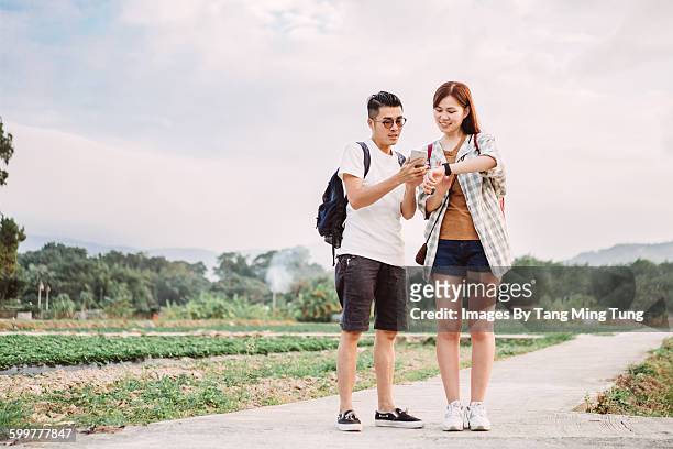 young lady & man using smartphone & smartwatch - time phone stock pictures, royalty-free photos & images
