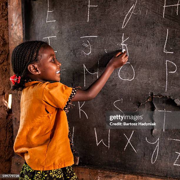 african little girl during english class, southern ethiopia, east africa - child writing on chalkboard stock pictures, royalty-free photos & images