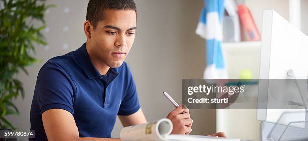 concentrating on his studies - students working on pc school stock pictures, royalty-free photos & images