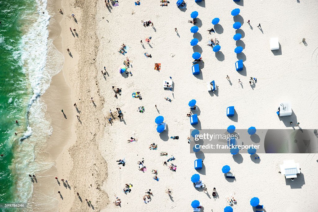 Crowds sunbathing on the beach in miami