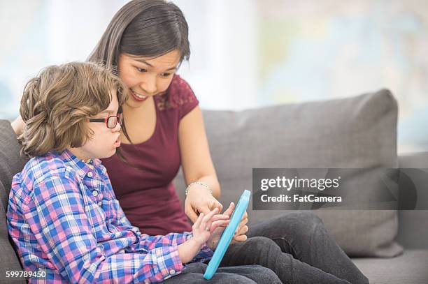 tutor teaching a child with educational games - child psychologist stock pictures, royalty-free photos & images