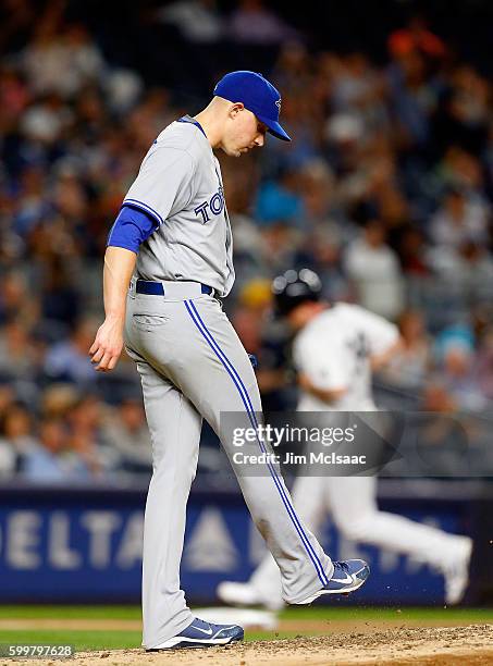 Aaron Sanchez of the Toronto Blue Jays stands on the mound after surrendering a fourth inning home run against Brian McCann of the New York Yankees...