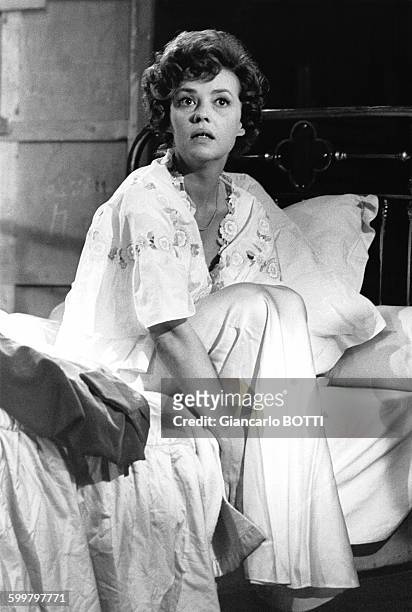 Actrice Jeanne Moreau en chemise de nuit assise sur un lit durant une scène du film de Bunuel, en novembre 1963, en France .