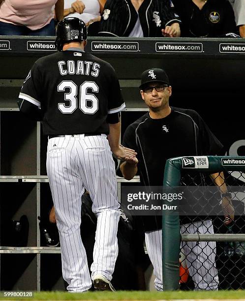 Jason Coats of the Chicago White Sox is congratulated by manager Robin Ventura after scoring against the Detroit Tigers on an RBI single by Omar...