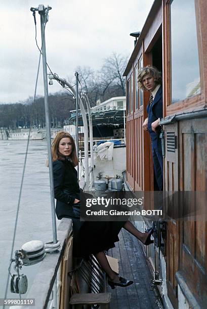 Actrice Olga Georges-Picot et le pilote automobile Johnny Servoz-Gavin sur une péniche à Paris, circa 1970, France .