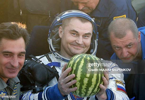 Russian cosmonaut Alexey Ovchinin, a member of the International Space Station crew, holds a watermelon after landing some 150 kms to the east of the...