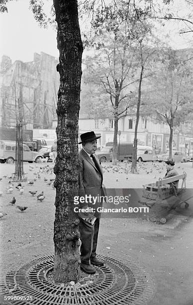 French poet Jacques Prévert walking down the streets of Paris, France, circa 1960 .