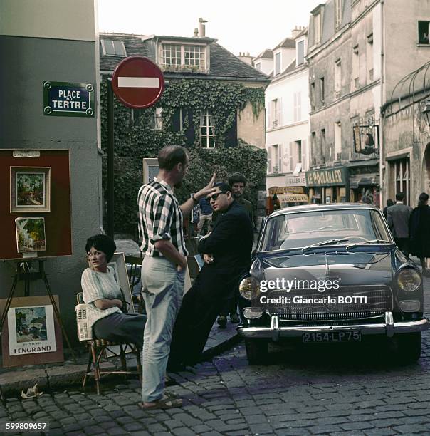 Peugeot 404 car at the Place du Tertre in Montmartre area in Paris, France, circa 1960 .