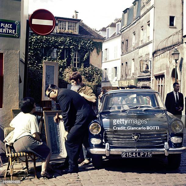 Peugeot 404 car at the Place du Tertre in Montmartre area in Paris, France, circa 1960 .