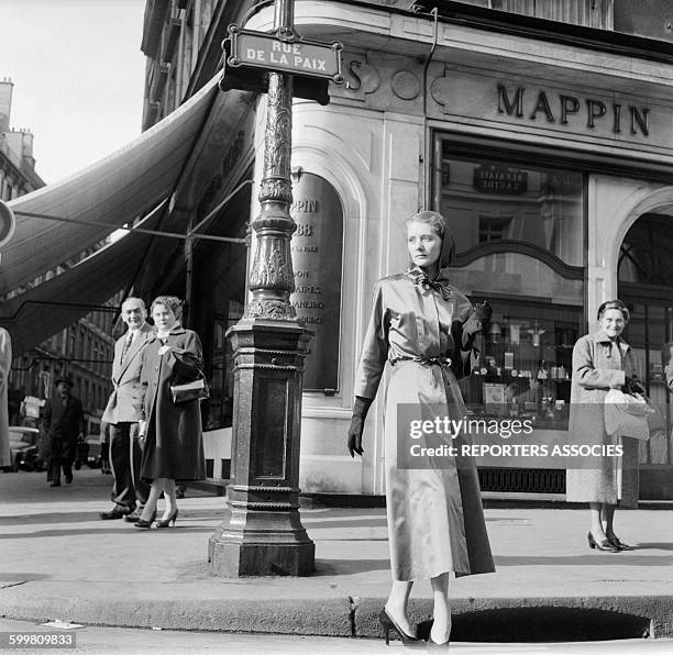 An Elegant Woman Strolling rue de la Paix, in Paris, France, circa 1950 .
