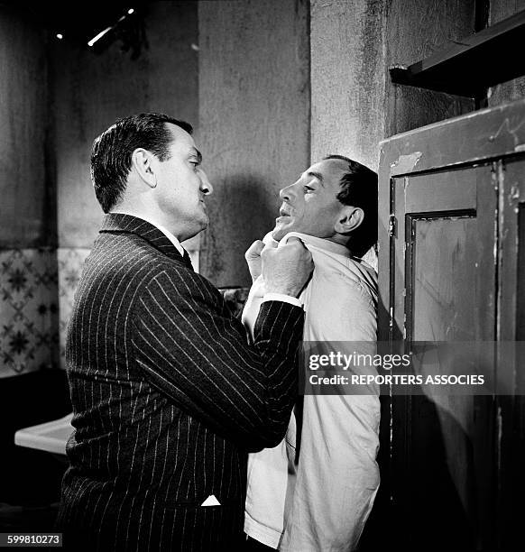 Lino Ventura and Charles Aznavour on the set of the Movie 'La Métamorphose des Cloportes' directed by Pierre Granier-Deffere in France, in 1965 .