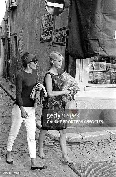 Brigitte Bardot with a Friend Strolling in Saint-Tropez, France, on June 19, 1963 .