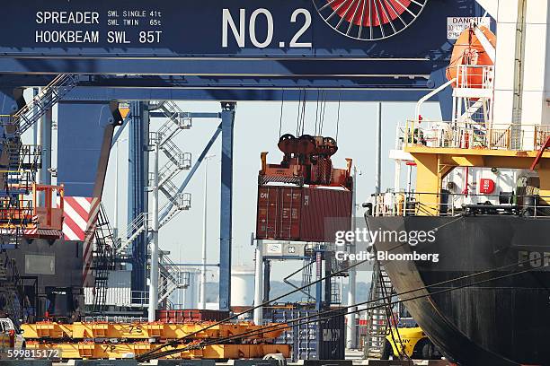 Shipping container is loaded onto a ship at the Port Botany container terminal in Sydney, Australia, on Tuesday, Sept. 6, 2016. Australia's annual...