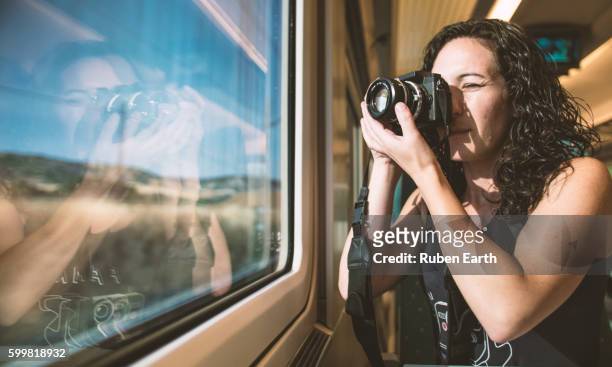 woman takes a picture through the train window - bloggerin stock-fotos und bilder
