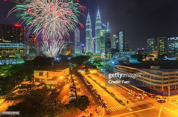 night view of kuala lumpur skyline during merdeka day celebration with colorful fireworks performed - malaysia skyline stock pictures, royalty-free photos & images