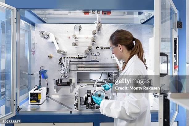 scientist making lithium ion battery samples in battery research facility - lithium ion battery stock pictures, royalty-free photos & images