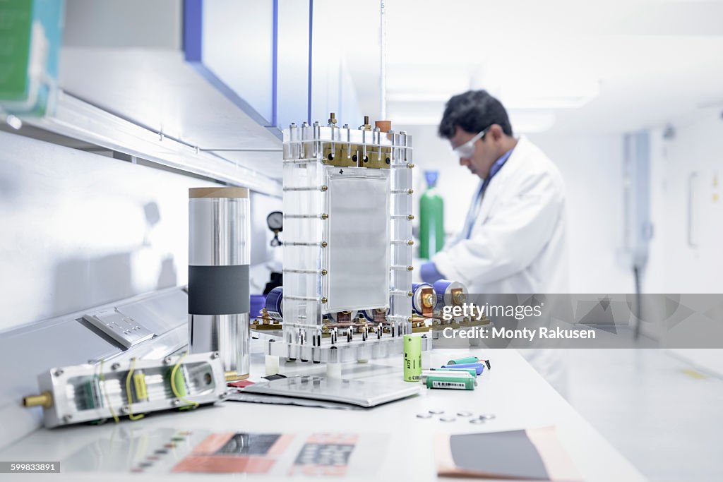 Scientist assembles lithium ion battery samples in battery research facility