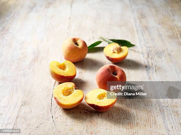 peaches, halved and whole - halved stock pictures, royalty-free photos & images