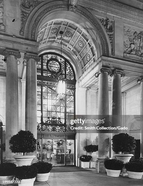 Grand front entrance of the Los Angeles Biltmore Hotel with ornate carved arch and glass doors, Los Angeles, California, 1953.